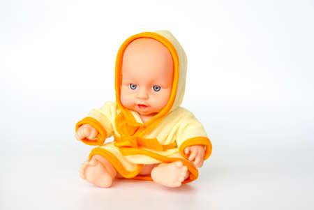 A toy baby in a bright dressing gown.の写真素材
