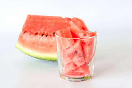 Red ripe watermelon, sliced on a white background. Watermelon slices in a glass.の写真素材