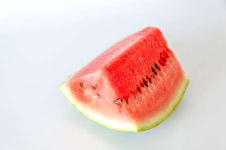 Red ripe watermelon sliced on a white background. Watermelon slices lie on the surface. White background.の写真素材