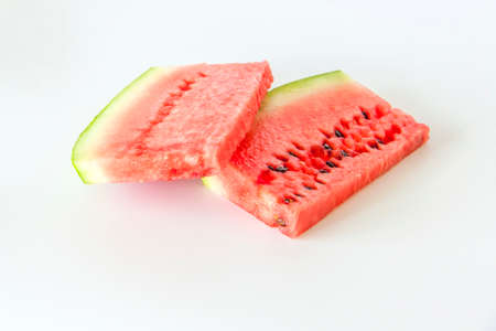 Red ripe watermelon sliced on a white background. Watermelon slices lie on the surface. White background.の写真素材