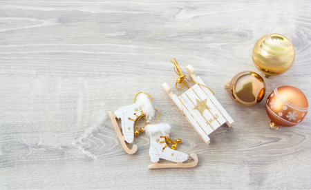 Happy New year and merry Christmas. Christmas background with decorations. Christmas card with Golden balls, wooden sleigh and skates for decorating the Christmas tree.の写真素材