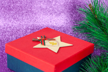 Christmas gift. Gift under the Christmas tree on a purple background. Christmas and new year.