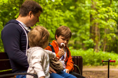Children have fun in the park. Walk, play and eat ice cream. Emotions, joy.の写真素材