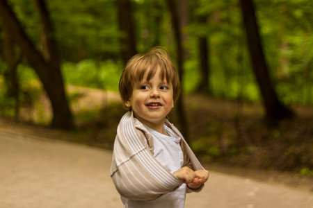 Preschooler has fun in the park. Take a walk, play and have fun. Emotions, joy. Portrait of a child.