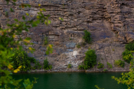 Landscape of a natural canyon at sunset. Rocky coast. At the top of the canyon. There is water below.の写真素材