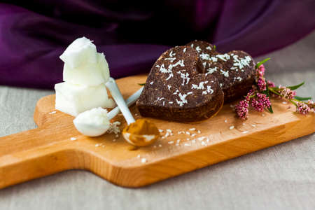 on the table there are handmade chocolates made of coconut oil, coconut chips and cocoa. dessert according to the recipe of proper nutrition. diet for weight lossの写真素材