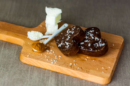 on the table there are handmade chocolates made of coconut oil, coconut chips and cocoa. dessert according to the recipe of proper nutrition. diet for weight lossの写真素材