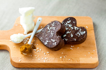 on the table there are handmade chocolates made of coconut oil, coconut chips and cocoa. dessert according to the recipe of proper nutrition. diet for weight lossの写真素材