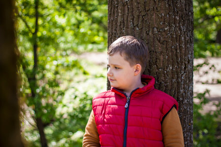 Portrait of a boy in the forest in spring. Take a walk in the green park in the fresh air. The magical light from the sun's rays is left behind. Space for copying. selective focus. Springの写真素材