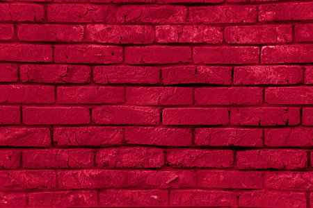 The texture of a red painted brick wall. Grunge background. brick surface. close-up background. Texture for the background.Viva Magenta Background colorの写真素材