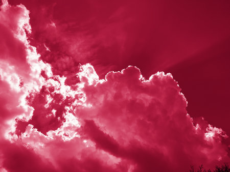 The sun's rays break through the dark clouds in the sky. Beautiful spectacular conceptual background of meditation. Beautiful sky.Viva Magenta Background colorの写真素材