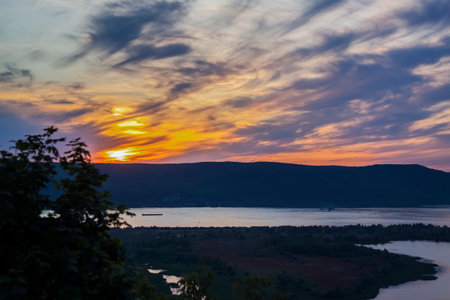sunset on the Volga river. natural landscape. reflection, blue sky and yellow sunlight. landscape during sunset.の写真素材
