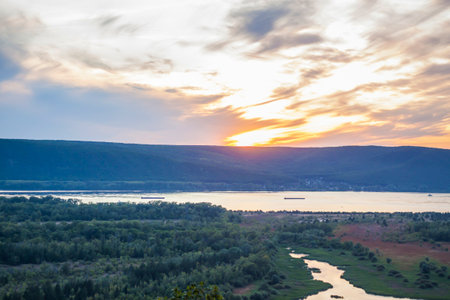 sunset on the Volga river. natural landscape. reflection, blue sky and yellow sunlight. landscape during sunset.の写真素材