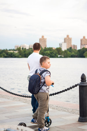 2022-07-17. Russia. Moscow. Northern River Station. Promenade. Walking along the embankment on scooters on a summer day.のeditorial素材