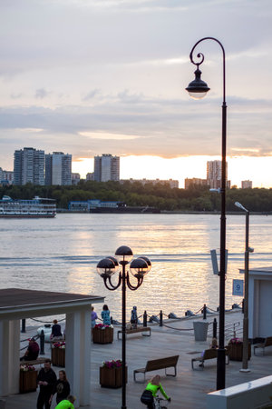 2022-07-17. Russia. Moscow. Northern River Station. Promenade. Walking along the embankment on scooters on a summer day.のeditorial素材