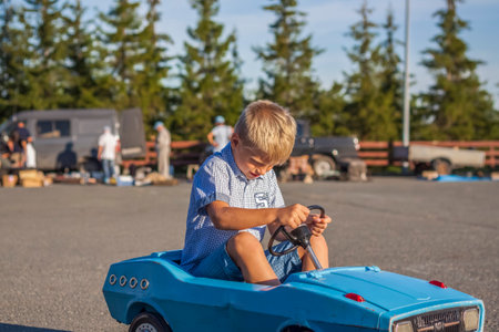 2022-08-12 Tatarstan, Verkhneuslonsky district, village. Savino. Resort town "Sviyazhsky hills". Kazan Festival of Historical Technologies. Children ride on children's retro cars.のeditorial素材