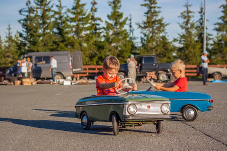 2022-08-12 Tatarstan, Verkhneuslonsky district, village. Savino. Resort town "Sviyazhsky hills". Kazan Festival of Historical Technologies. Children ride on children's retro cars.のeditorial素材