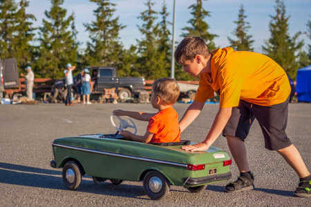 2022-08-12 Tatarstan, Verkhneuslonsky district, village. Savino. Resort town "Sviyazhsky hills". Kazan Festival of Historical Technologies. Children ride on children's retro cars.のeditorial素材