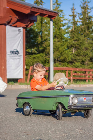 2022-08-12 Tatarstan, Verkhneuslonsky district, village. Savino. Resort town "Sviyazhsky hills". Kazan Festival of Historical Technologies. Children ride on children's retro cars.のeditorial素材