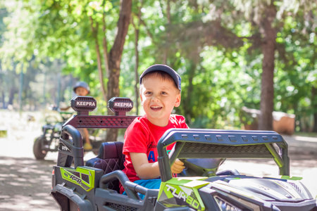 2022-08-16 Russia. Togliatti. entertainment park. Little boys compete on children's ATVs and cars. A fun pastime. Natural images with natural emotions. Childhoodのeditorial素材