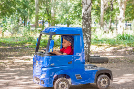 2022-08-16 Russia. Togliatti. entertainment park. Little boys compete on children's ATVs and cars. A fun pastime. Natural images with natural emotions. Childhoodのeditorial素材