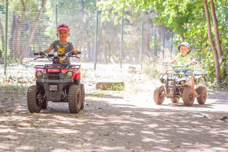 2022-08-16 Russia. Togliatti. entertainment park. Little boys compete on children's ATVs and cars. A fun pastime. Natural images with natural emotions. Childhoodのeditorial素材