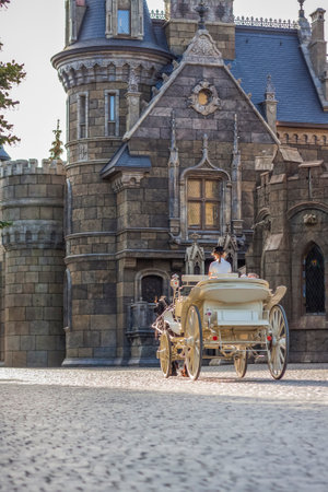 2022-08-16 Russia, Samara, Garibaldi Castle Tourist Center in the village of Khryashchevka, Samara region. The rider drives the carriage around the Castle.のeditorial素材