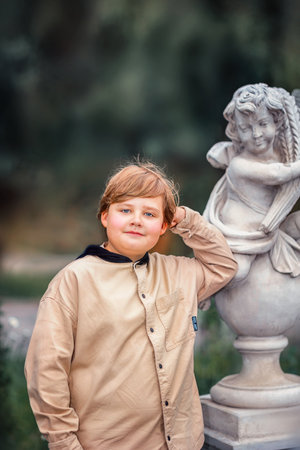 A young handsome boy of European appearance likes to spend time outside. Not staged portraits of a boy. It's a great time to relax. Portrait of a child.の写真素材