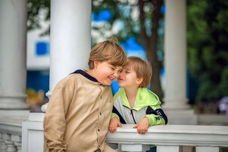 Two brothers, two Young handsome boys of European appearance, enjoy spending time on the street. It's a great time to relax. Portrait of a child.の写真素材