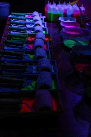 bottles filled with multicolored fluorescent paints for coloring pictures. children's bright colors....
