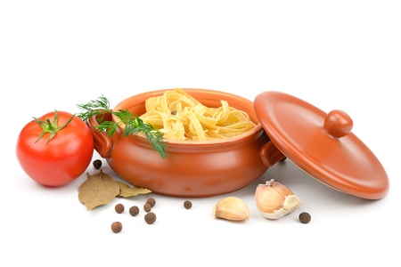 Clay pot with pasta, vegetables and spices isolated on white background.の写真素材