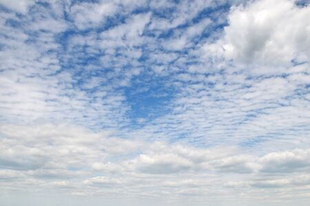 white fluffy clouds in the blue skyの写真素材