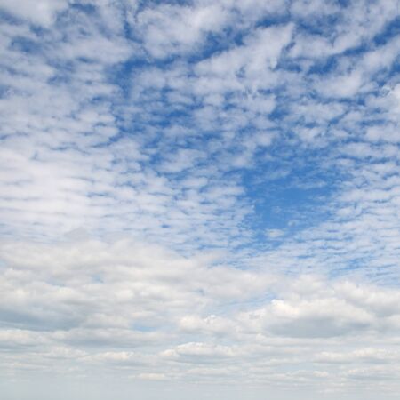 white fluffy clouds in the blue skyの写真素材
