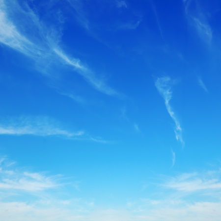 white fluffy clouds in the blue skyの写真素材