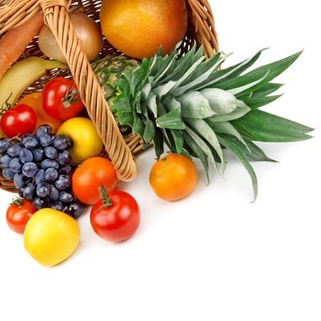 fruits and vegetables in a basket isolated on white backgroundの写真素材