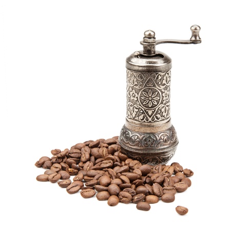 manual coffee grinder and coffee beans isolated on white backgroundの写真素材