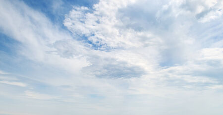 fluffy clouds in the blue skyの写真素材