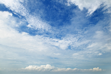 The white cumulus clouds against the blue skyの写真素材