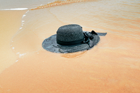 beach hat on a background of sand and waterの写真素材