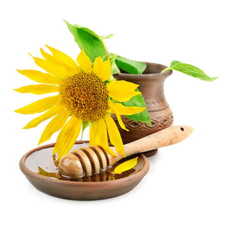 clay dish with honey drizzler and flowers sunflowersの写真素材