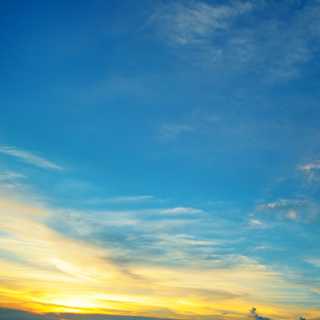 the sun sets in the cloudsの写真素材