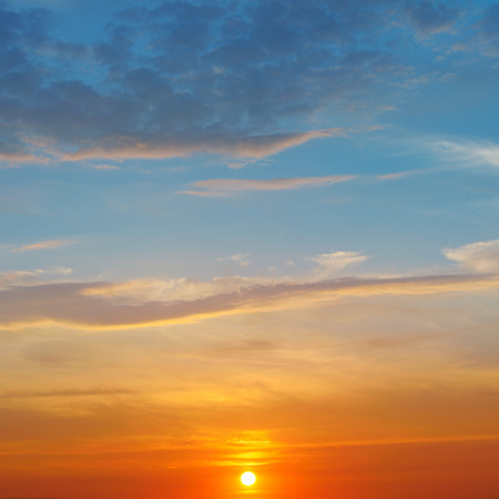 the sun rays illuminate the sky above the horizonの写真素材