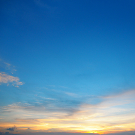 the sun sets in the cloudsの写真素材