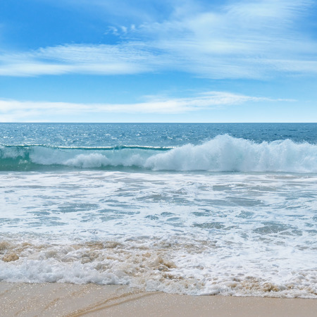 ocean, sandy beach and blue skyの写真素材
