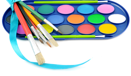 watercolor paints and brushes isolated on white backgroundの写真素材