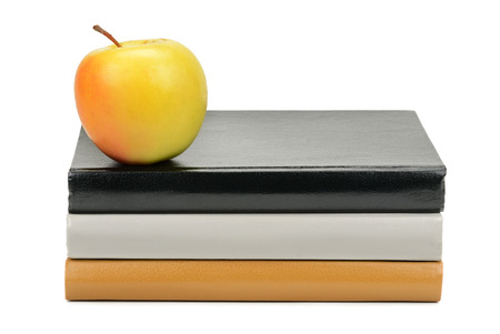 books and apple isolated on white backgroundの写真素材