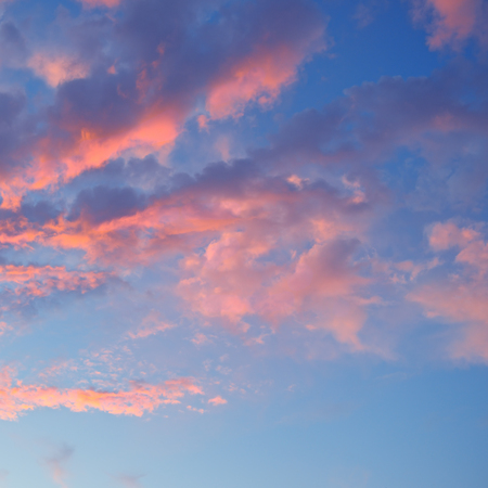 the sun sets in the cloudsの写真素材