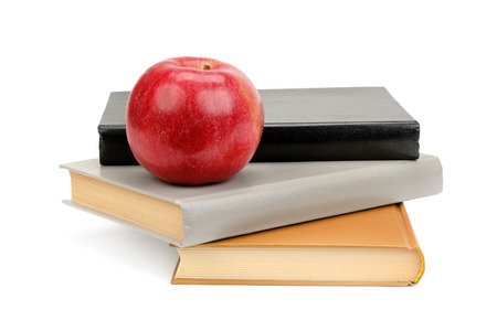 books and apple isolated on white backgroundの写真素材