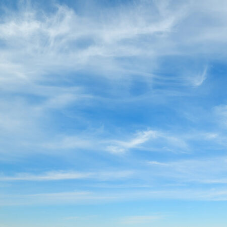 fluffy clouds in the blue skyの写真素材