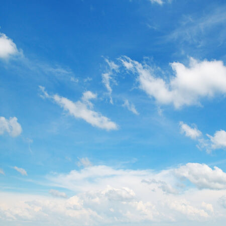 fluffy clouds in the blue skyの写真素材